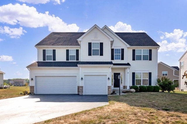 view of front of house with a garage and a front lawn