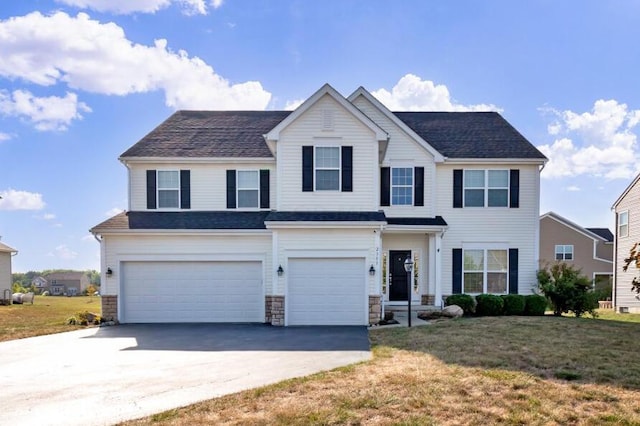 2353 Killdeer Pl, Galena, OH 43021 - view of front of property featuring an attached garage, asphalt driveway, a front yard, and stone siding