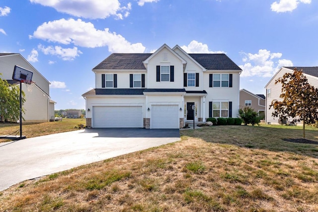 view of front of home featuring a front yard and a garage