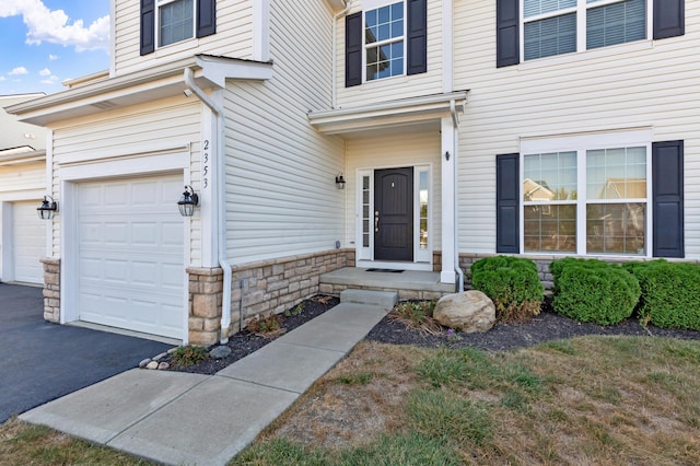 view of exterior entry with a garage