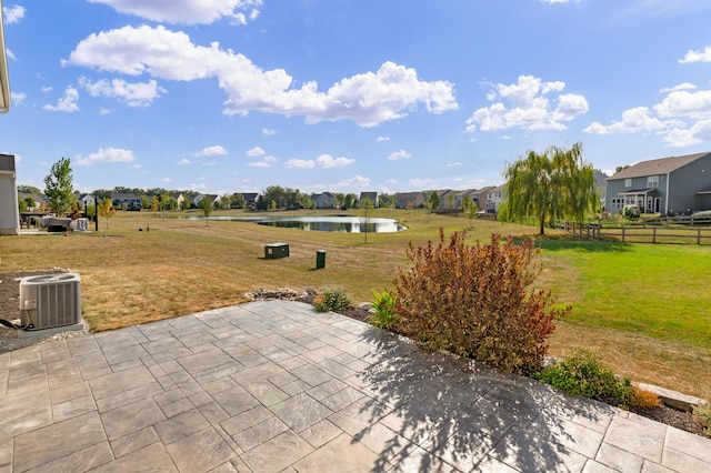 view of patio featuring central AC unit and a water view