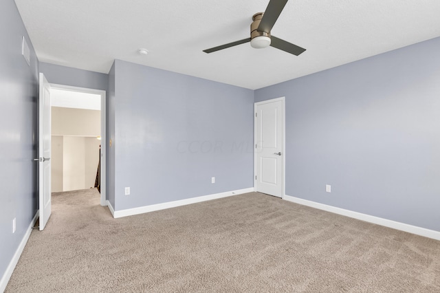 unfurnished bedroom featuring light carpet and ceiling fan