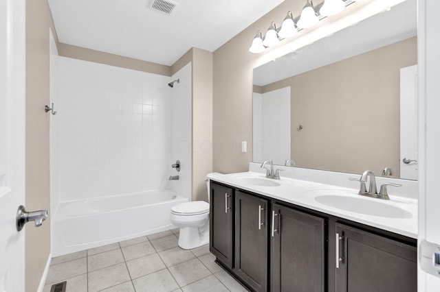 full bathroom with tile patterned floors, vanity, tiled shower / bath combo, and toilet