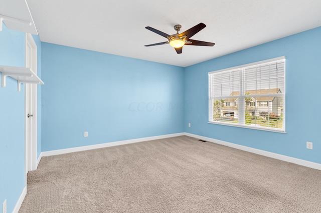 empty room with ceiling fan and carpet floors