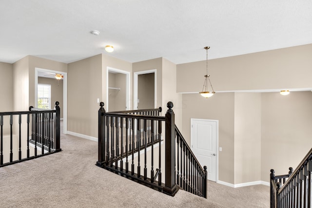 hall featuring light colored carpet