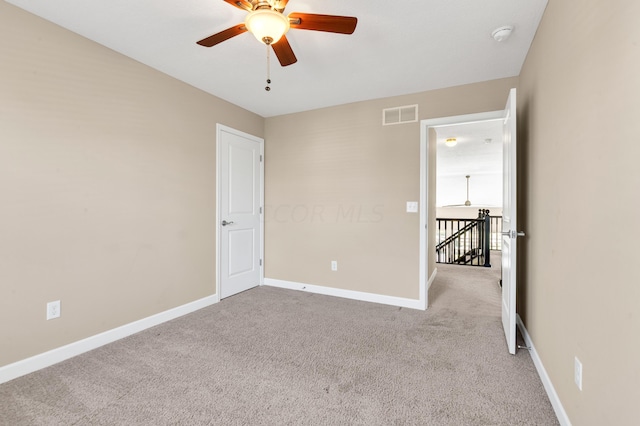 unfurnished bedroom with ceiling fan and light carpet