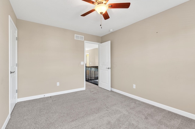 carpeted empty room with ceiling fan