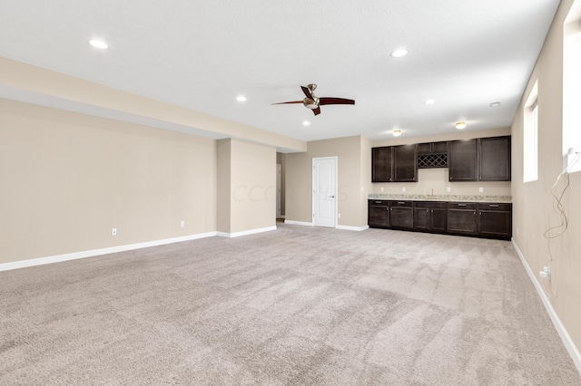 unfurnished living room with ceiling fan and light carpet