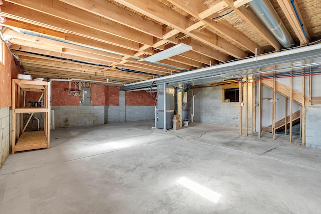 basement featuring electric panel and heating unit