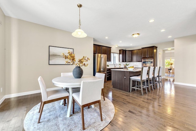 dining area featuring hardwood / wood-style flooring and sink