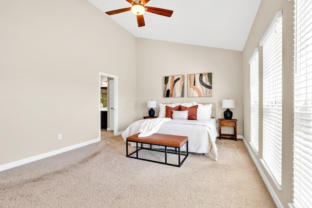 bedroom with light carpet, high vaulted ceiling, multiple windows, and ceiling fan