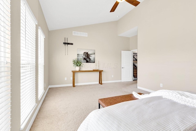 carpeted bedroom featuring vaulted ceiling, multiple windows, and ceiling fan