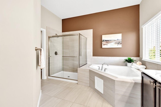 bathroom with shower with separate bathtub, vanity, and tile patterned floors