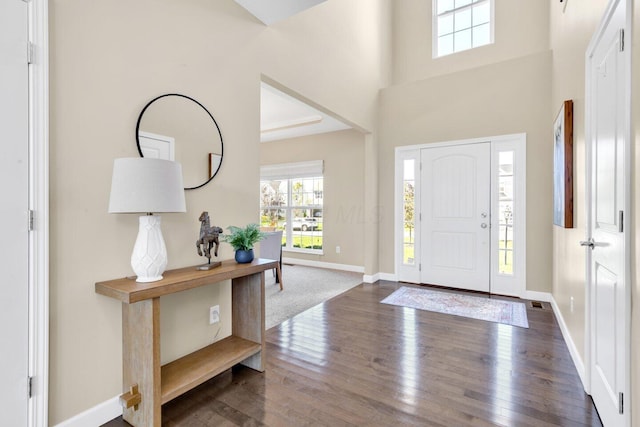 entryway with dark hardwood / wood-style flooring