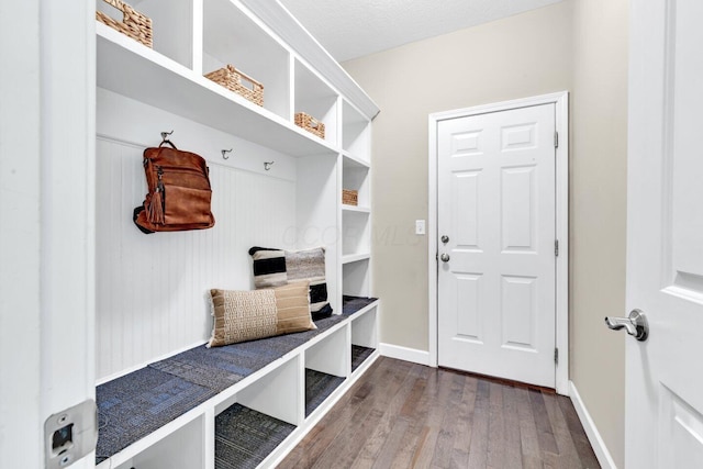 mudroom featuring a textured ceiling and hardwood / wood-style flooring