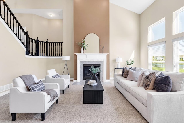 carpeted living room with a high ceiling