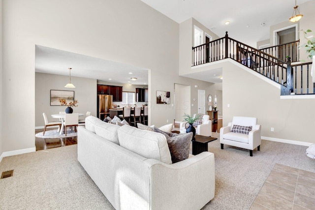 2353 Killdeer Pl, Galena, OH 43021 - living area with light carpet, stairs, and a high ceiling