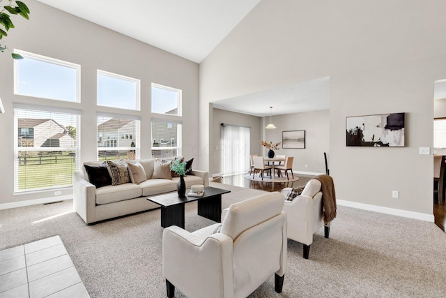 living room with light carpet and high vaulted ceiling