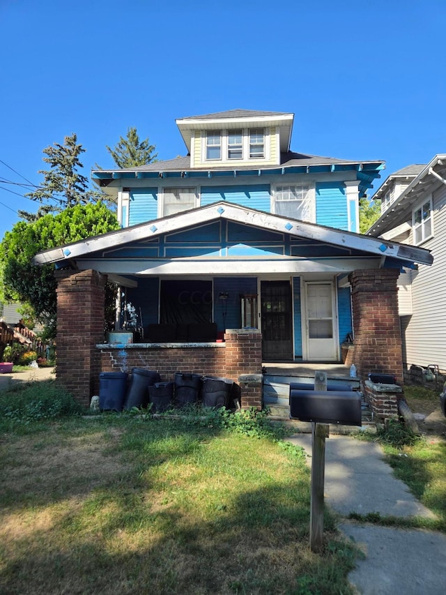 view of front facade with covered porch and a front yard