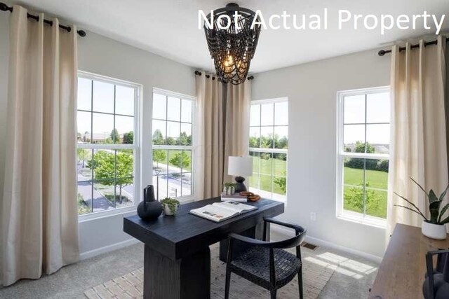 office space featuring a chandelier, a wealth of natural light, and baseboards