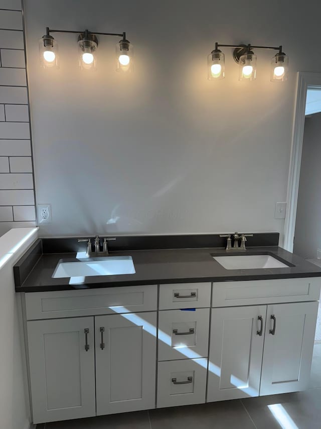 bathroom featuring double sink and tile patterned flooring