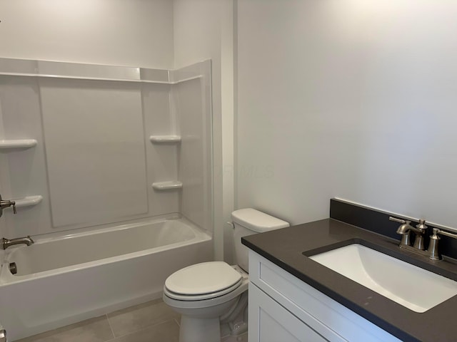 bathroom featuring shower / washtub combination, vanity, toilet, and tile patterned floors