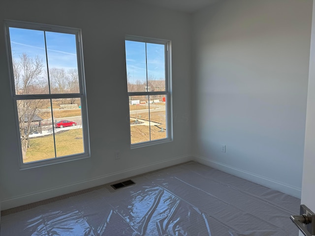 unfurnished room featuring visible vents and baseboards