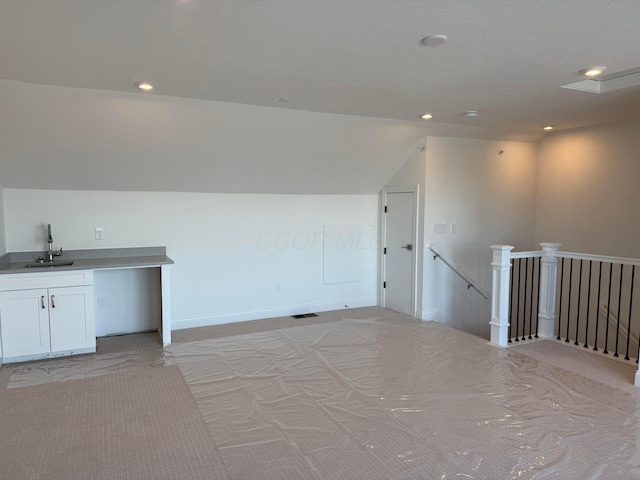 bonus room featuring light carpet, vaulted ceiling, a sink, and recessed lighting