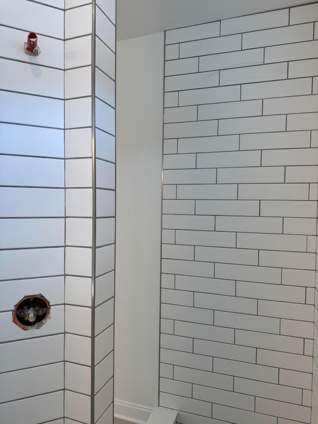 full bathroom with tiled shower