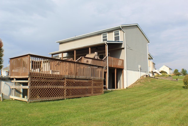 back of house featuring a yard and a deck