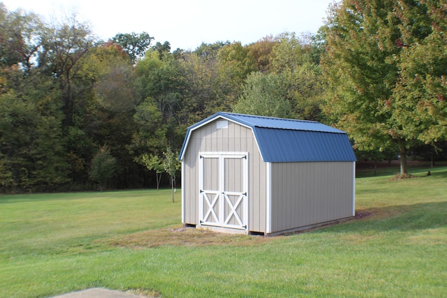 view of outdoor structure featuring a lawn