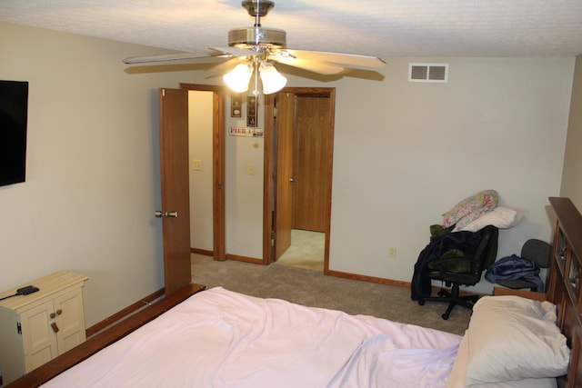 carpeted bedroom with a textured ceiling and ceiling fan