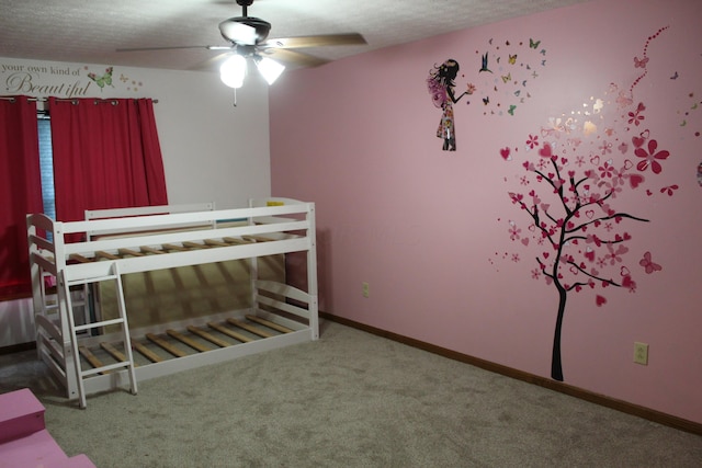 unfurnished bedroom featuring carpet flooring, a textured ceiling, and ceiling fan