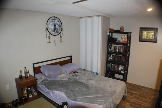 bedroom with ceiling fan and dark wood-type flooring