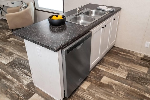 kitchen featuring white cabinetry, dishwasher, sink, dark hardwood / wood-style flooring, and kitchen peninsula