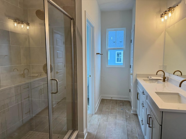 bathroom with vanity and a shower with shower door