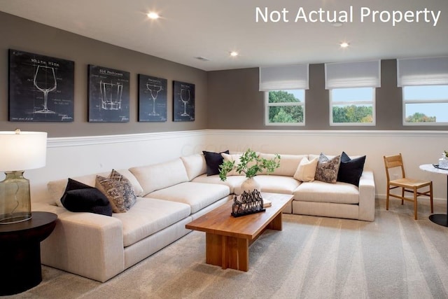 living room with a healthy amount of sunlight and light colored carpet