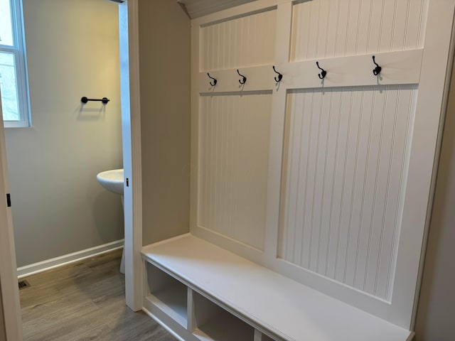 mudroom featuring light wood-style flooring and baseboards