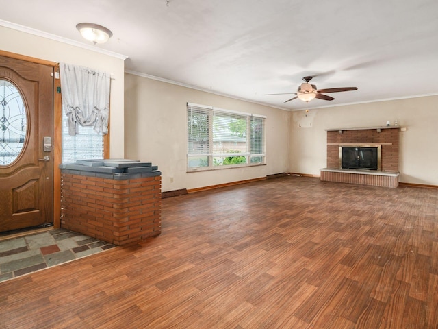 entrance foyer featuring hardwood / wood-style floors, a brick fireplace, ceiling fan, and crown molding