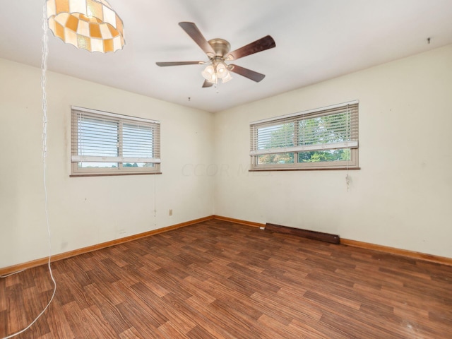 empty room featuring ceiling fan and dark hardwood / wood-style flooring