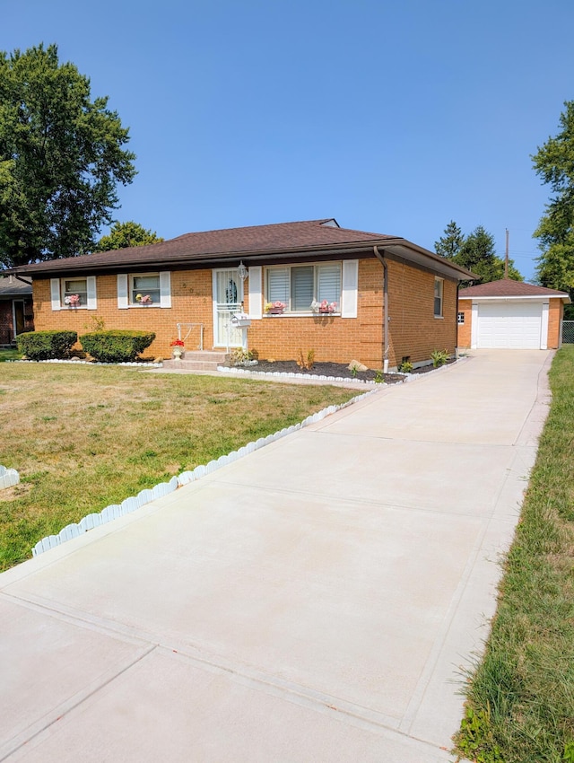 ranch-style house featuring a garage, an outbuilding, and a front yard