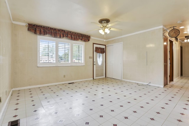 spare room featuring ceiling fan and ornamental molding