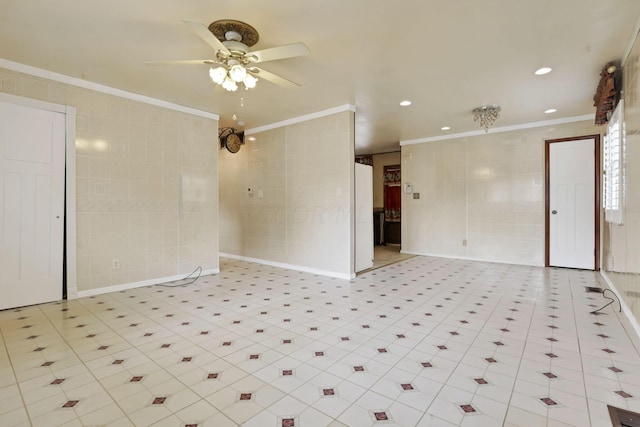 unfurnished room featuring ornamental molding, tile walls, and ceiling fan