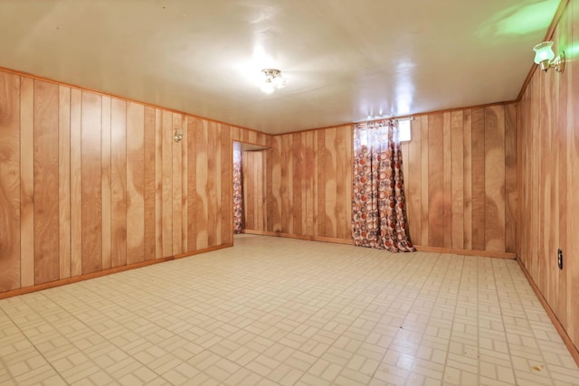 basement featuring wood walls