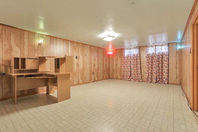 basement featuring wooden walls