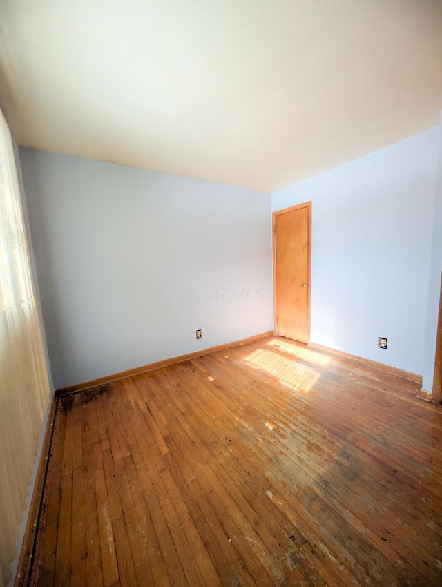 unfurnished room with hardwood / wood-style floors