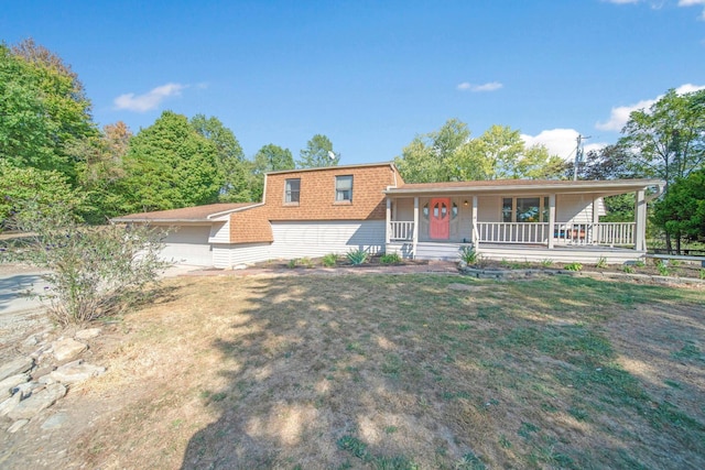 tri-level home with a front yard, a porch, and a garage