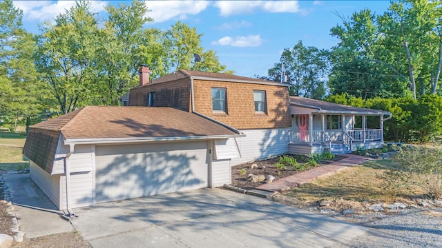 split level home featuring covered porch and a garage