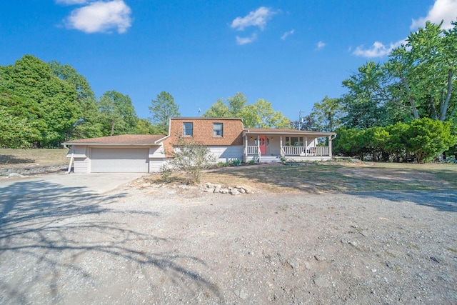 view of front of house with a porch and a garage