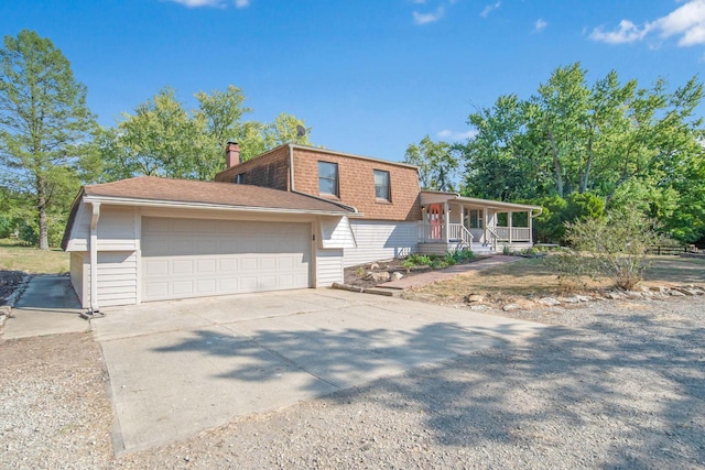 view of front of house featuring covered porch and a garage